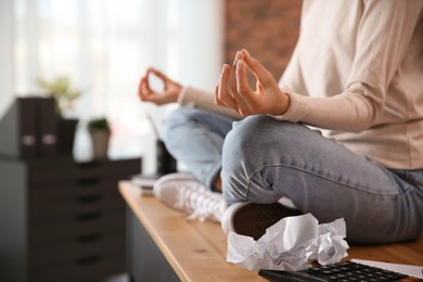 Photo of Woman meditating at workplace in office, closeup. Space for text