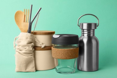 Photo of Composition with eco friendly products on turquoise background. Conscious consumption