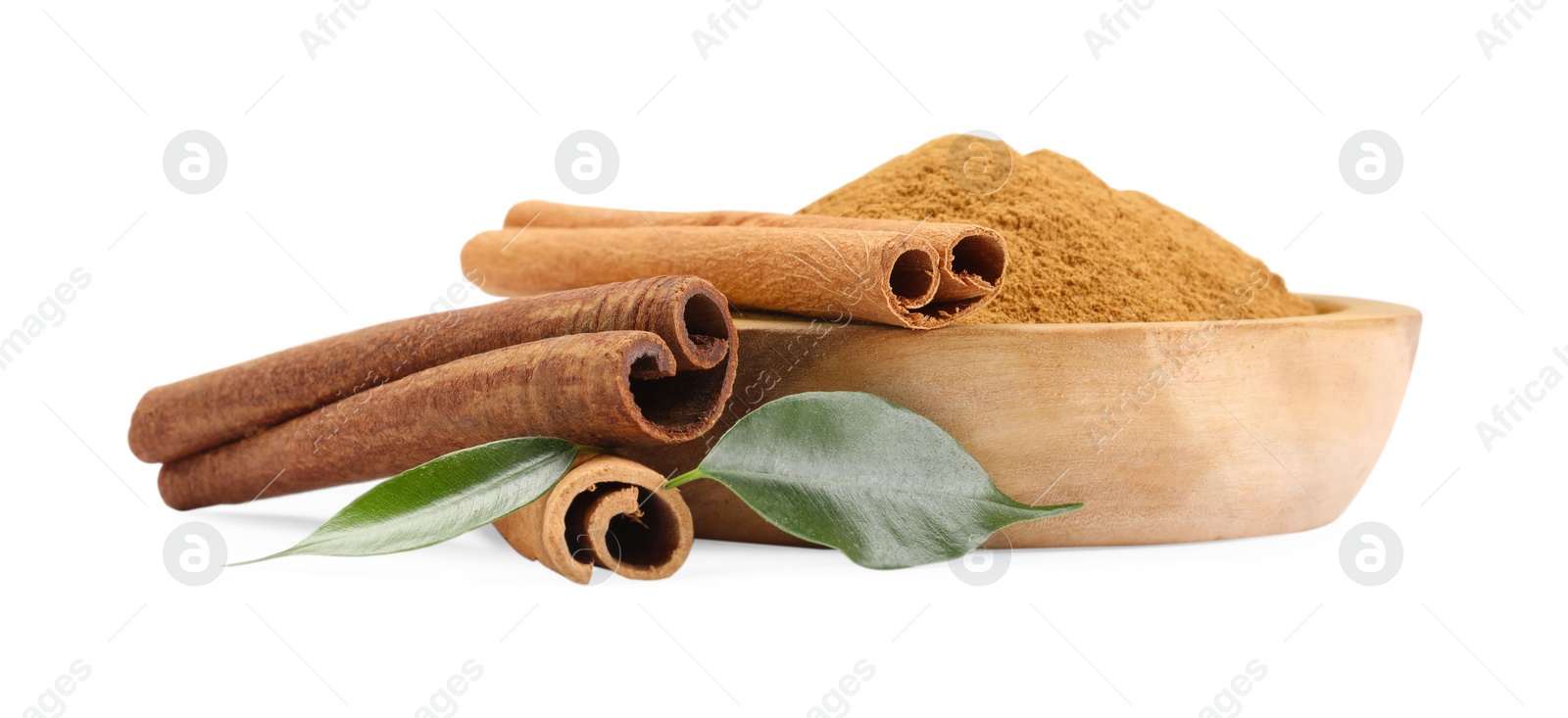 Photo of Dry aromatic cinnamon sticks, powder and green leaves isolated on white