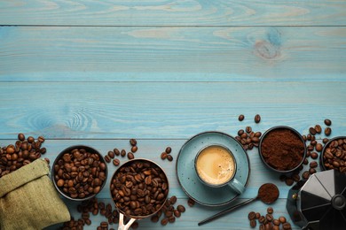 Photo of Coffee maker, beans, powder and cup of drink on light blue wooden table, flat lay. Space for text