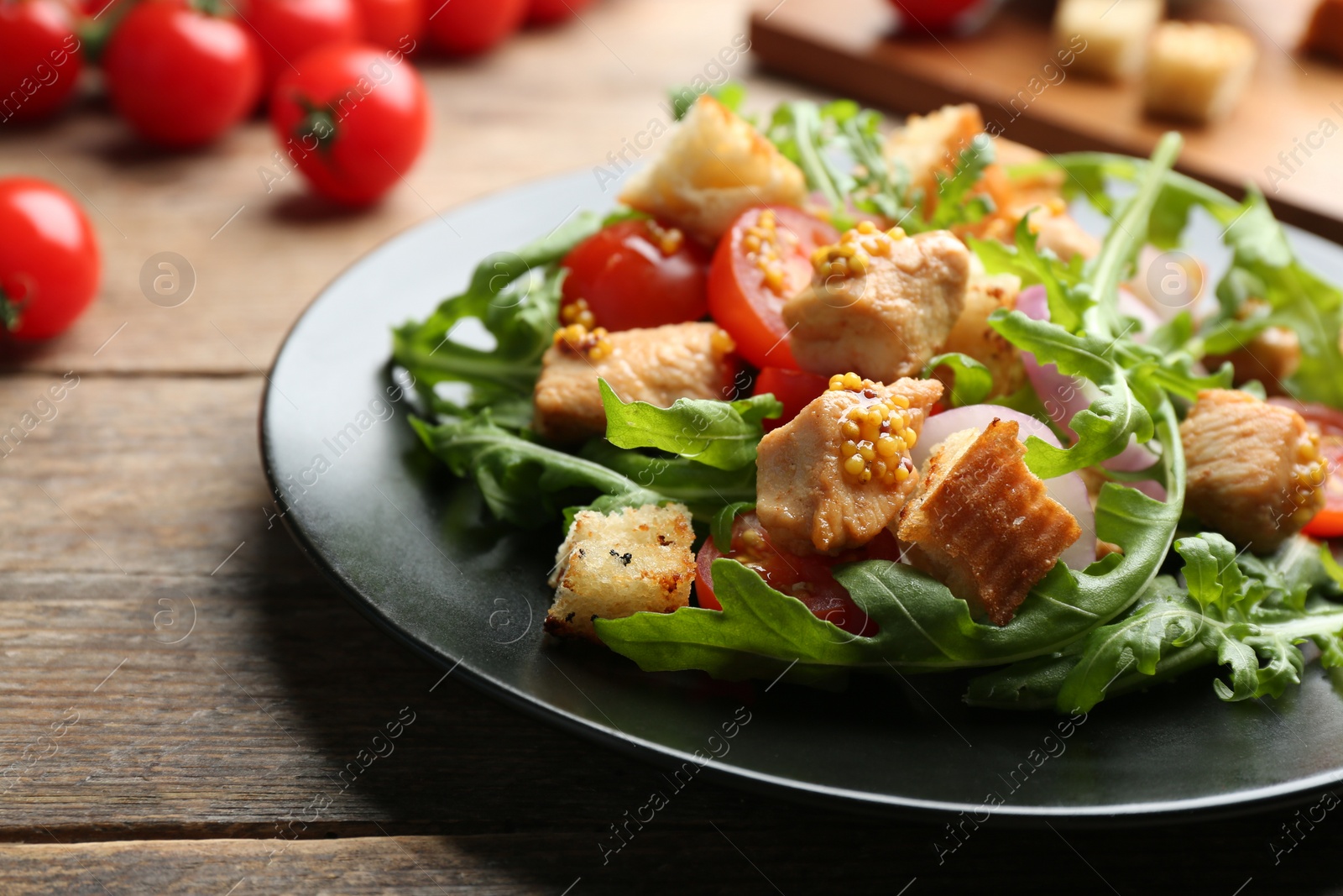 Photo of Delicious fresh chicken salad served on wooden table, closeup