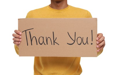 Man holding cardboard sheet with phrase Thank You on white background, closeup