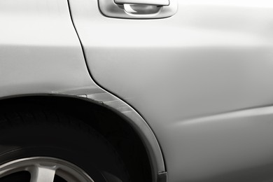 Photo of Modern gray car with scratch, closeup view