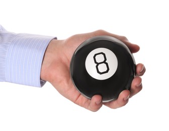 Photo of Man holding magic eight ball on white background, closeup