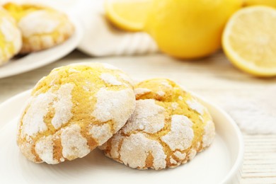 Tasty homemade lemon cookies on white wooden table, closeup