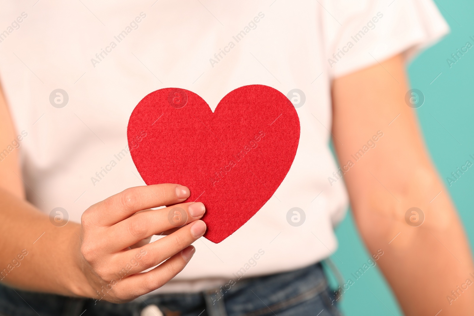 Photo of Woman holding heart, closeup. Blood donation