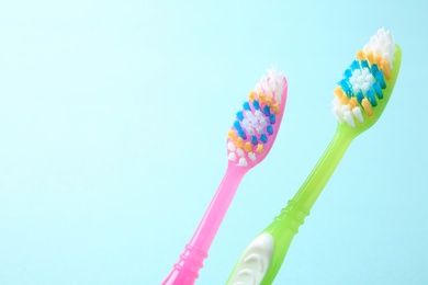 Photo of Manual toothbrushes on color background. Dental care