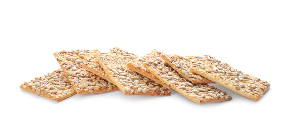 Photo of Delicious crispy crackers with different seeds isolated on white