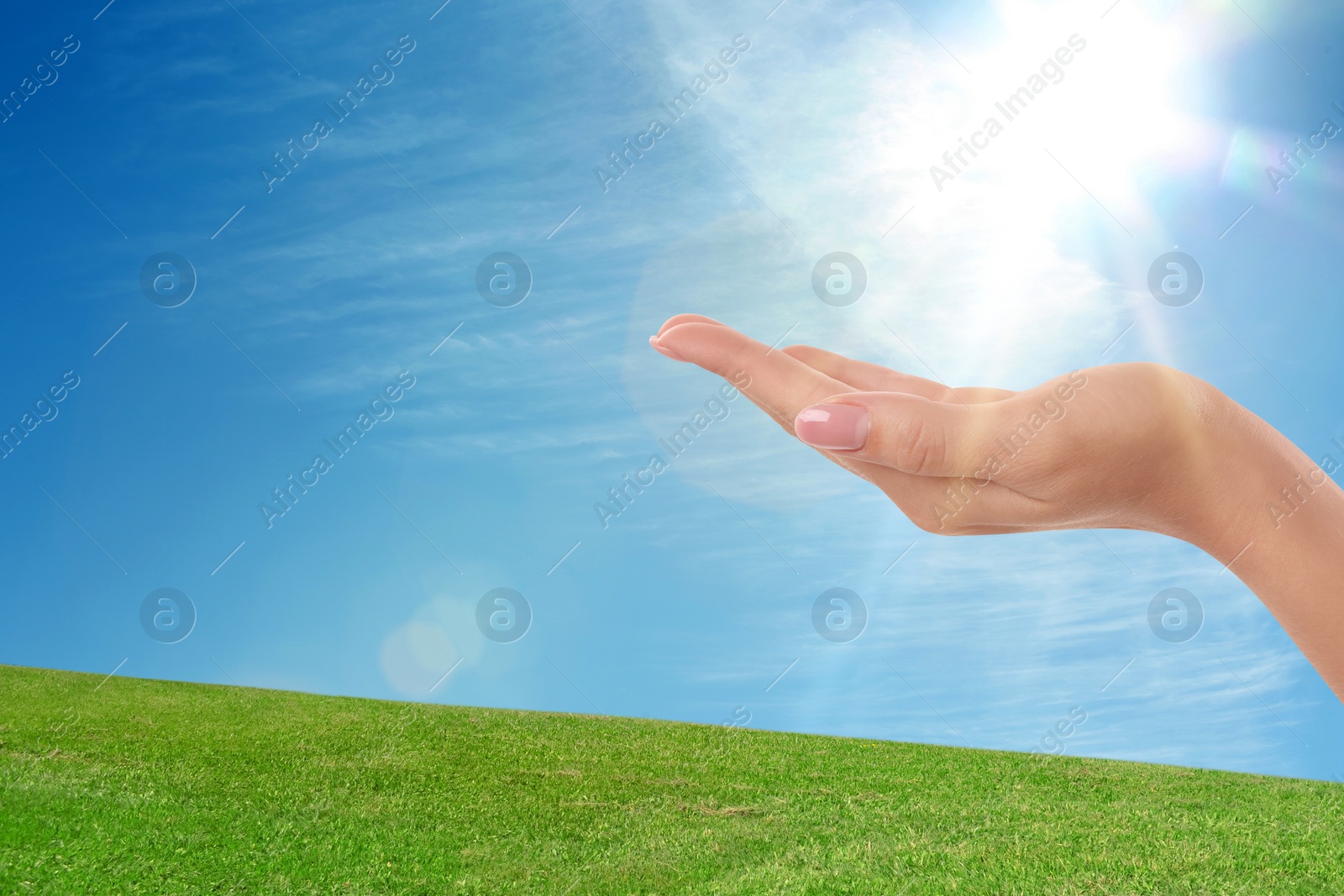 Image of Bright light in hand, closeup. Solar energy concept