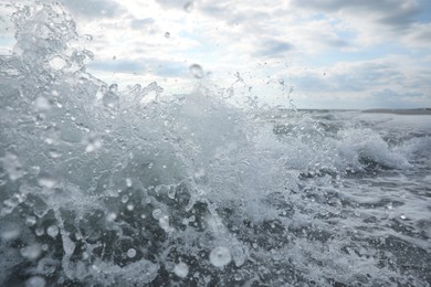 Photo of Sea waves rolling onto tropical beach, closeup view