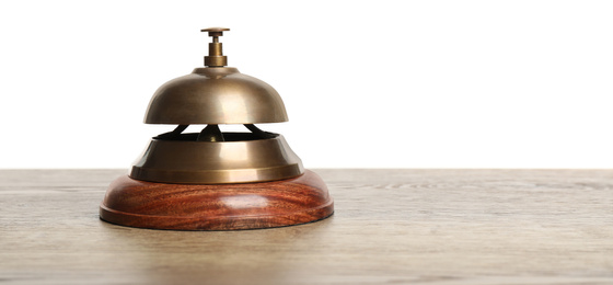 Hotel service bell on wooden table against white background