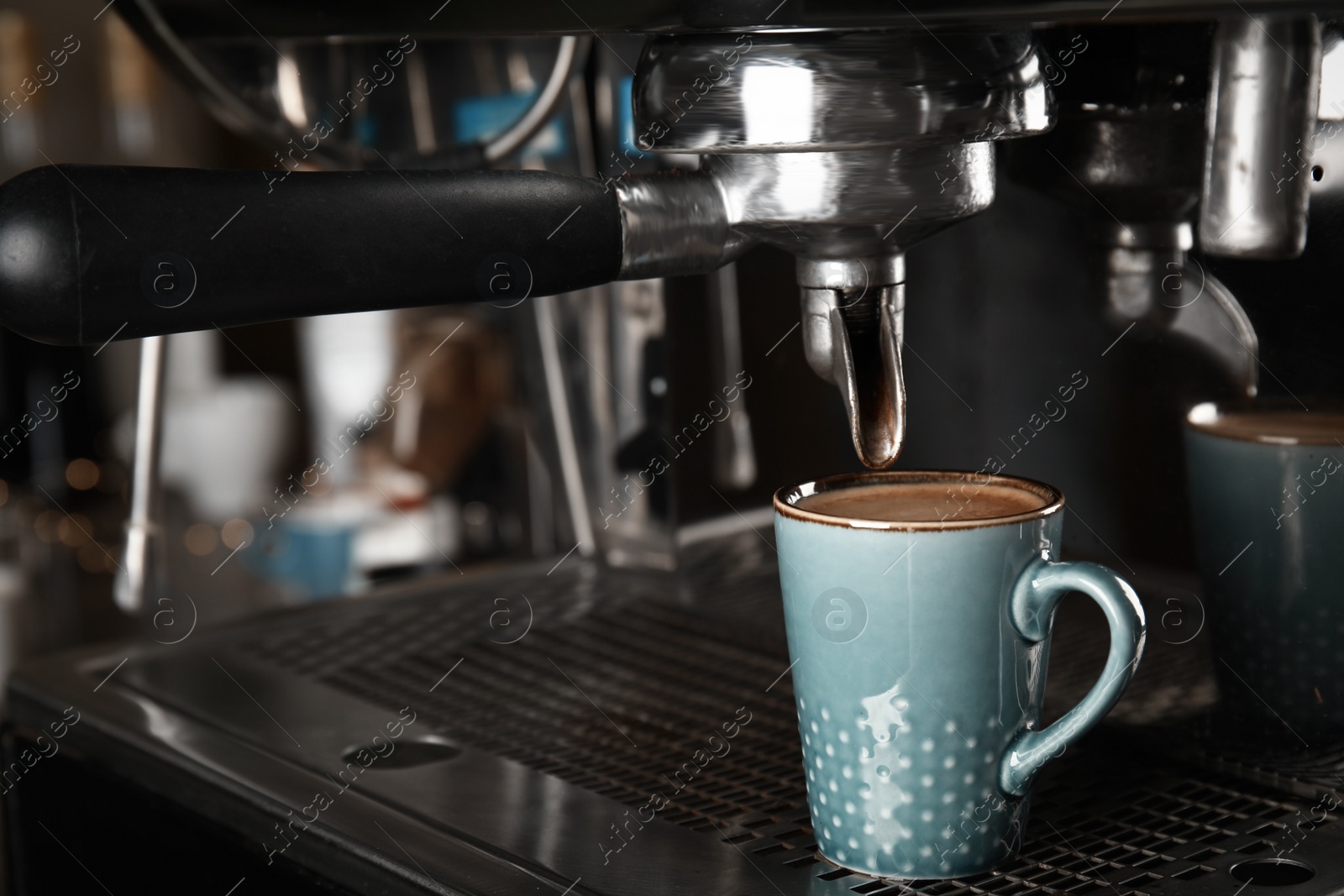 Photo of Making fresh aromatic espresso using professional coffee machine