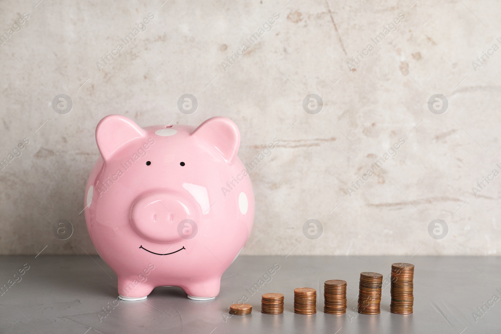 Photo of Piggy bank and different height coin stacks on color background. Space for text