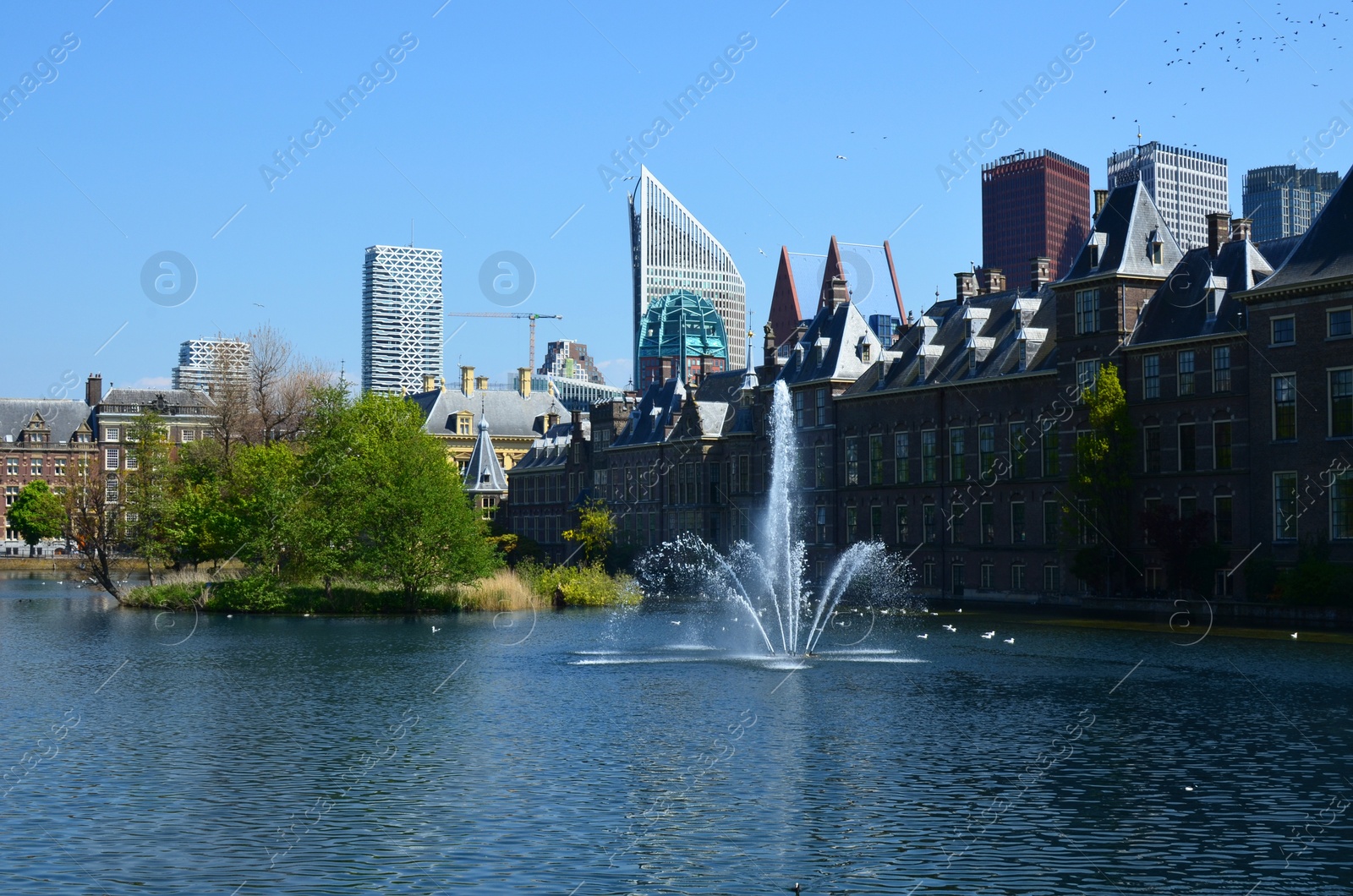 Photo of Hague, Netherlands - May 2, 2022: Beautiful view of city street with modern buildings and fountain