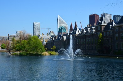 Photo of Hague, Netherlands - May 2, 2022: Beautiful view of city street with modern buildings and fountain