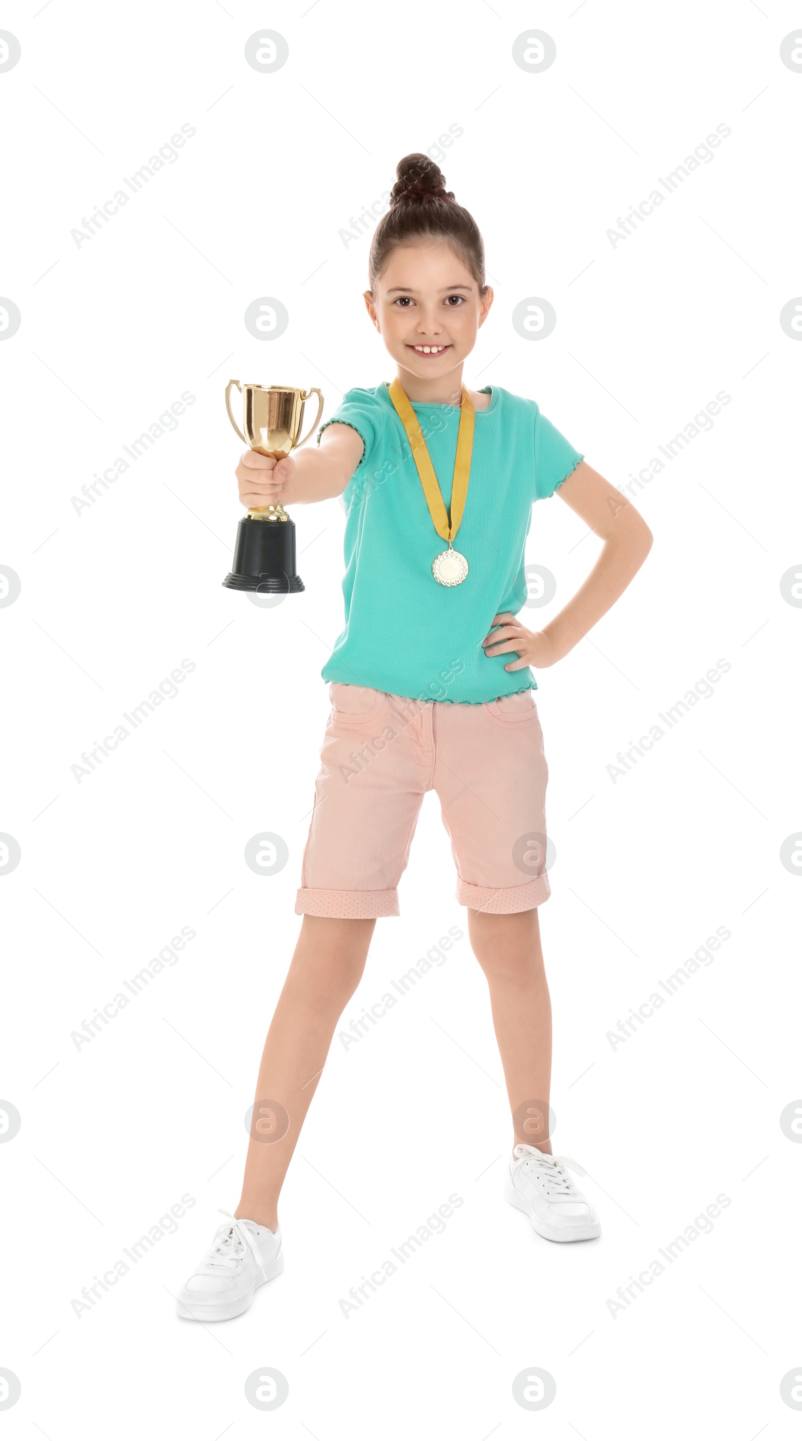 Photo of Happy girl with golden winning cup and medal isolated on white