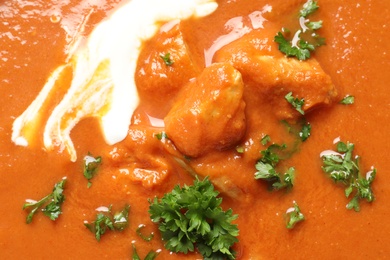 Photo of Delicious butter chicken as background, closeup. Traditional Murgh Makhani dish