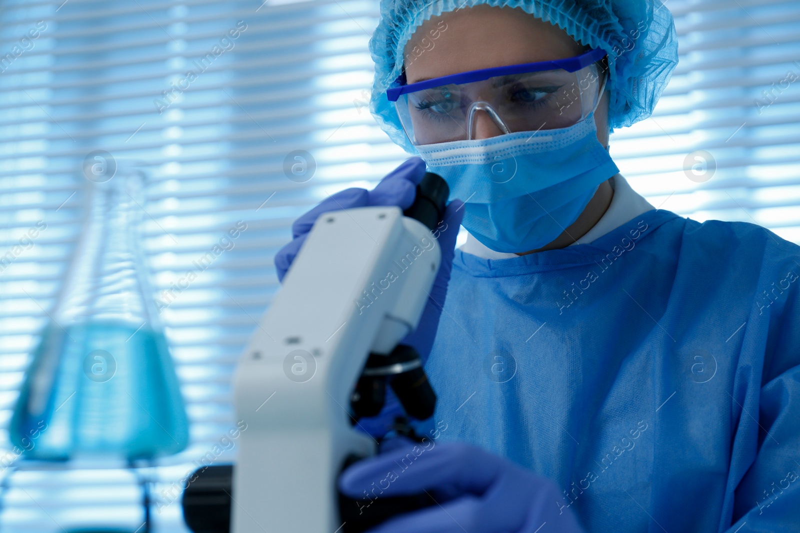 Photo of Scientist working with microscope in laboratory. Medical research