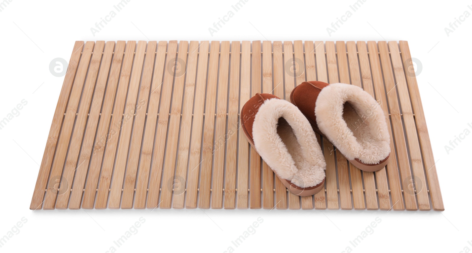 Photo of Bamboo rug with soft slippers isolated on white. Bath accessory