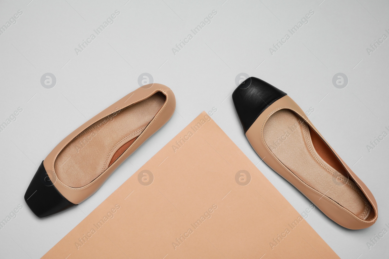 Photo of Pair of new stylish square toe ballet flats on colorful background, flat lay