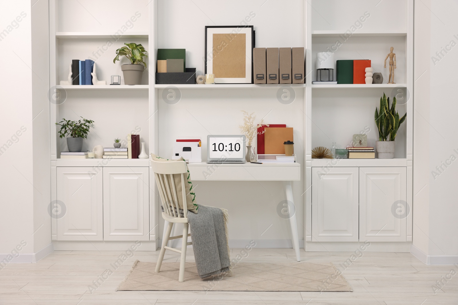 Photo of Cozy workspace with laptop on wooden desk at home