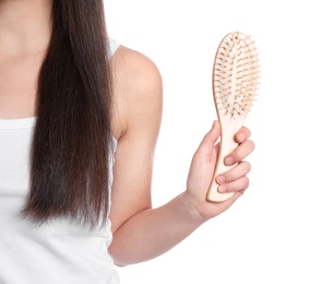 Photo of Woman holding hair brush on white background, closeup