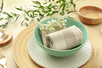 Photo of Elegant table setting with flowers and leaves