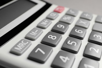 Photo of Calculator on grey background, closeup. Office stationery