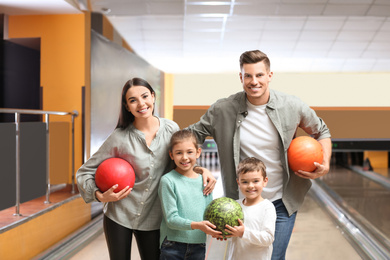 Happy family spending time together in bowling club