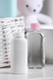 Photo of Bottles of baby cosmetic products on white table
