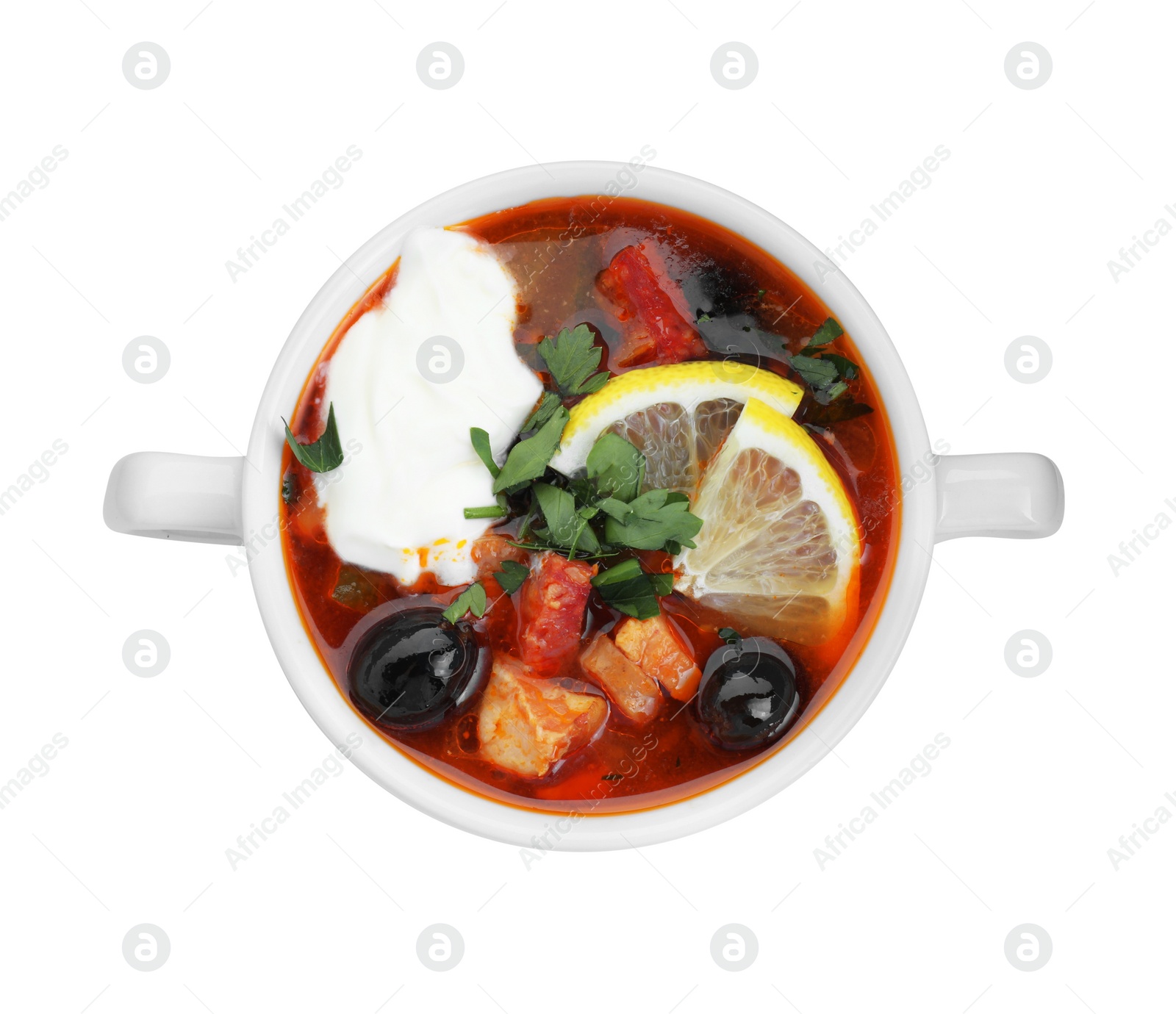 Photo of Meat solyanka soup with sausages, olives and vegetables in bowl isolated on white, top view