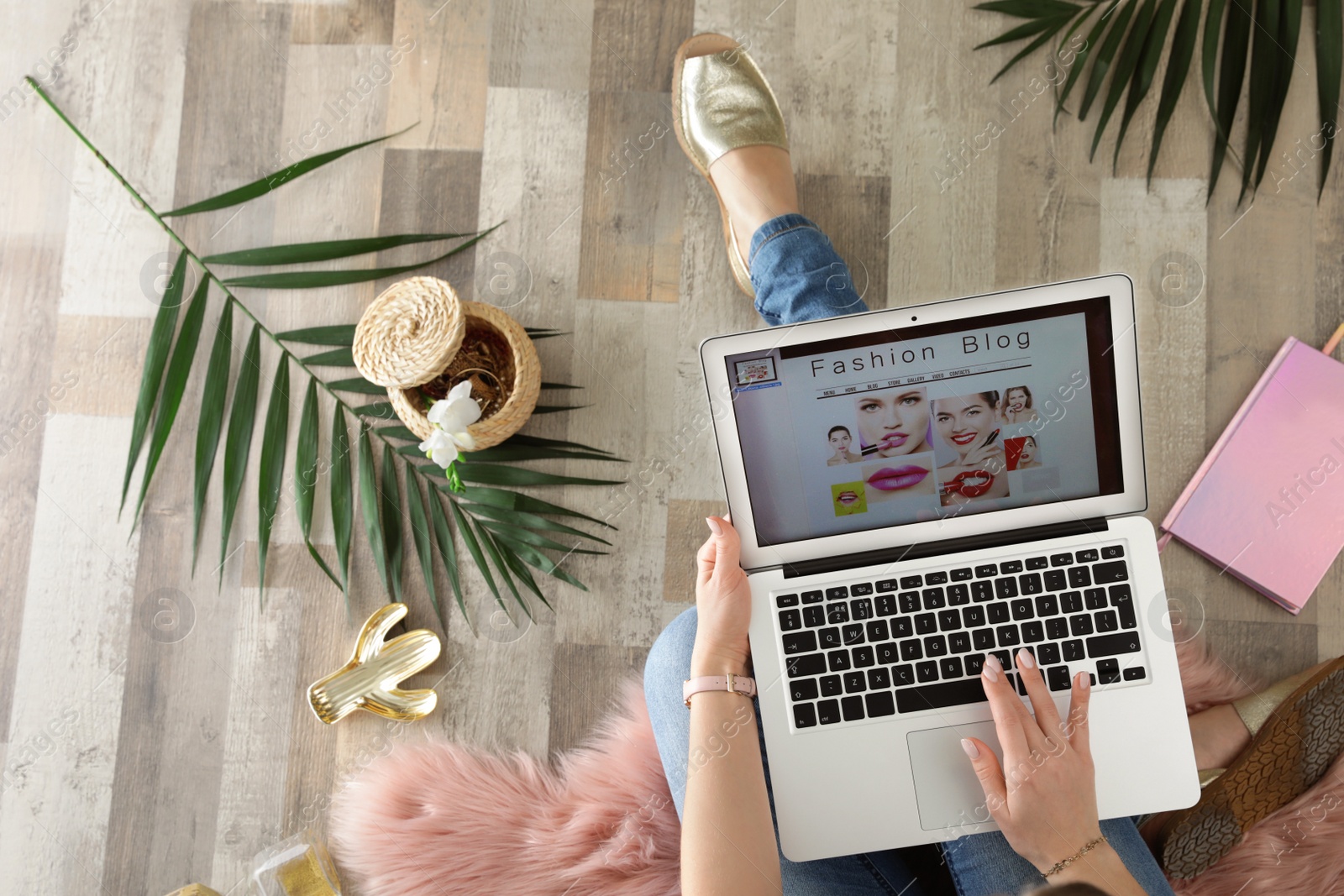 Photo of Woman and laptop with open fashion blogger site on floor, top view