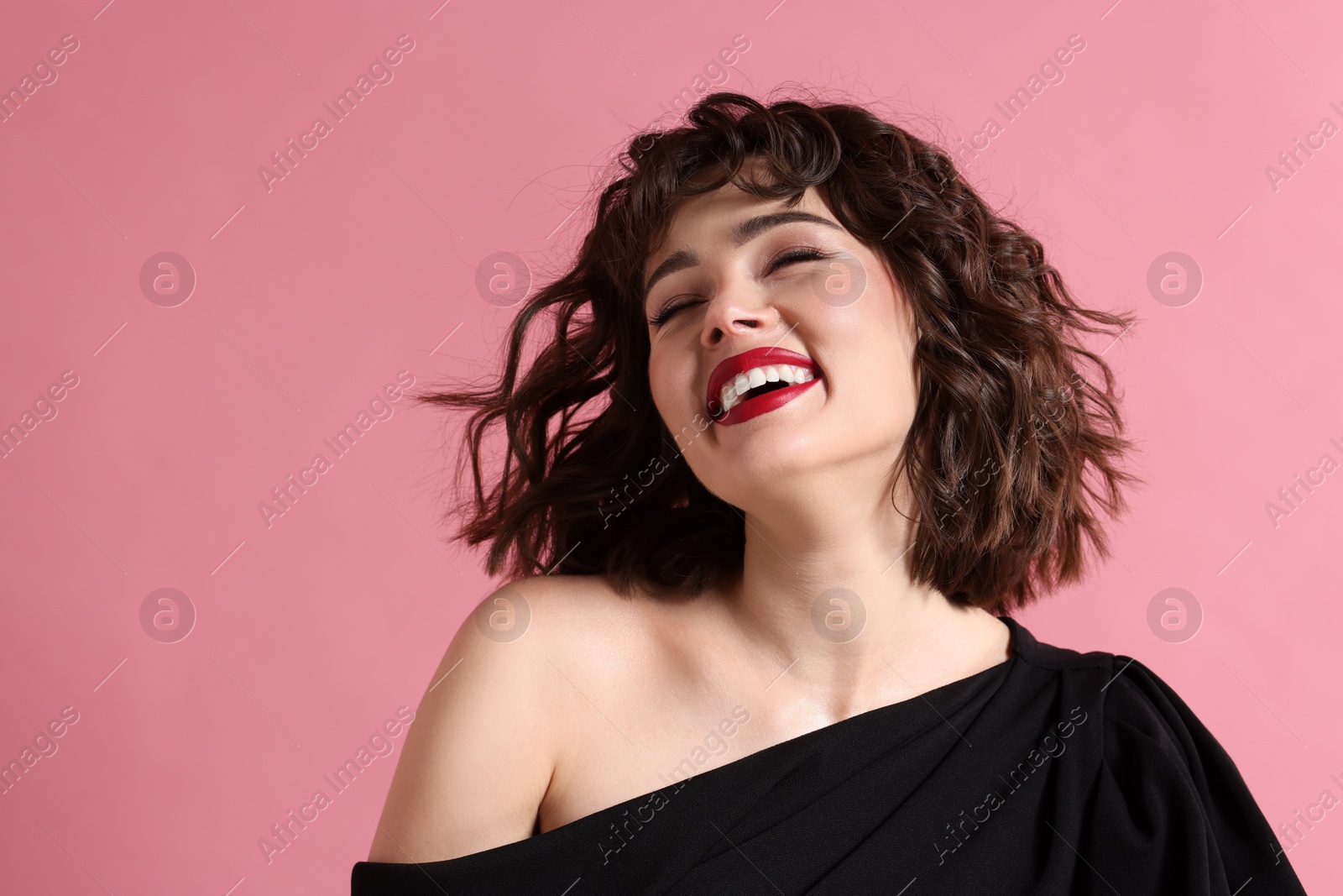 Photo of Portrait of beautiful young woman with wavy hairstyle on pink background. Space for text