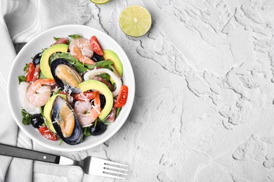 Photo of Bowl of delicious salad with seafood on white textured table, flat lay. Space for text