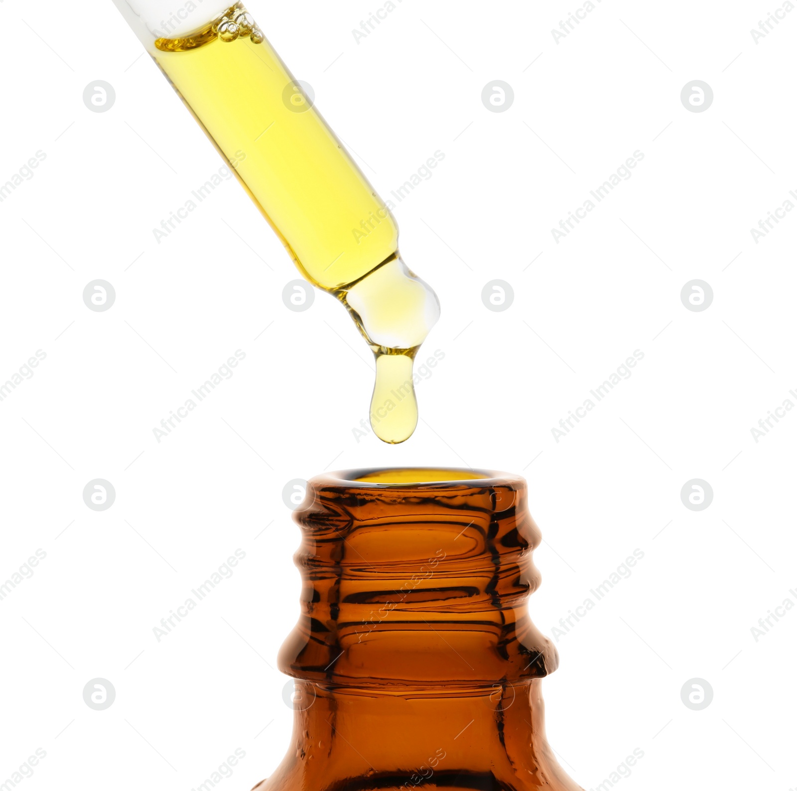 Photo of Dripping tincture from pipette into bottle isolated on white