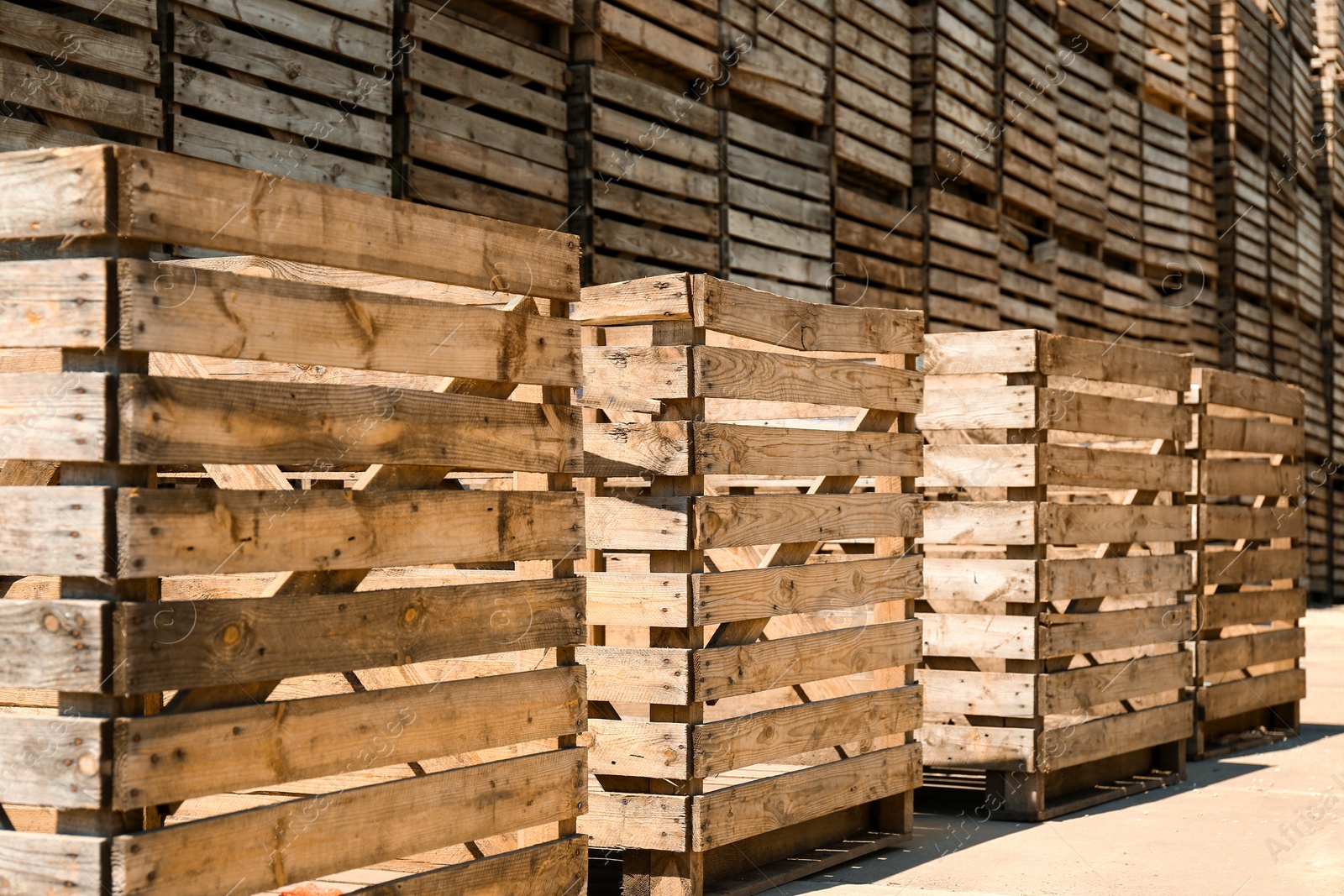 Photo of Old empty wooden crates outdoors on sunny day