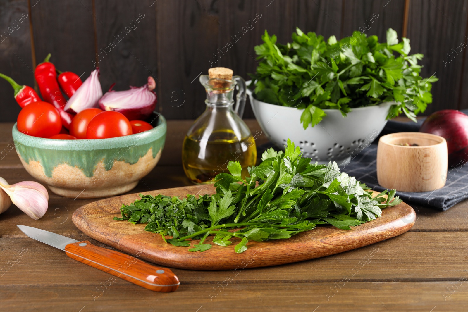 Photo of Fresh green parsley and different products on wooden table