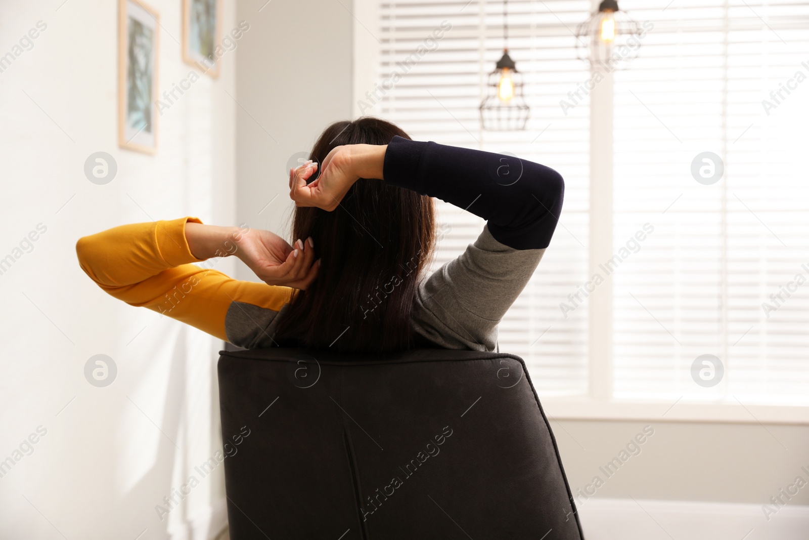 Photo of Young woman relaxing at home. Peaceful rest