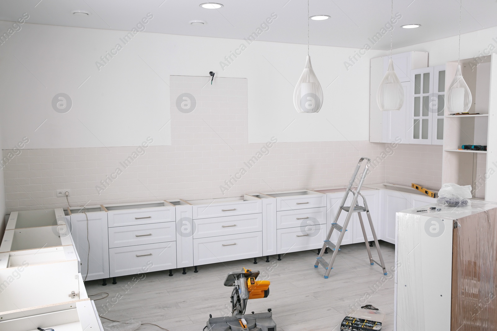 Photo of Stylish kitchen interior with newly installed furniture