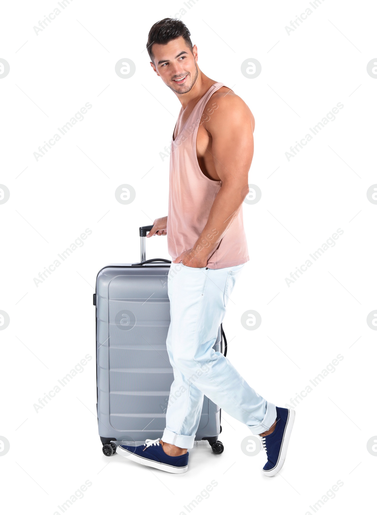 Photo of Young man walking with suitcase on white background