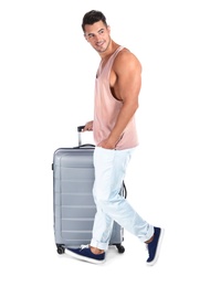 Photo of Young man walking with suitcase on white background