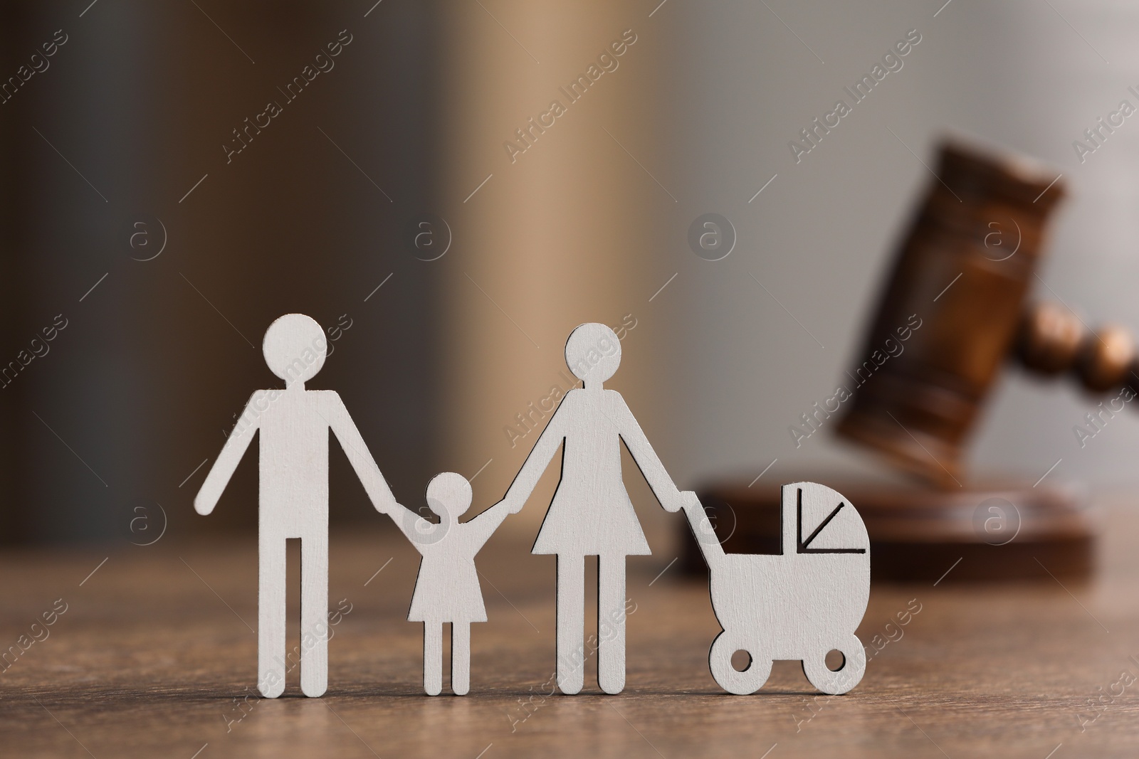 Photo of Family law. Figure of parents with children and gavel on wooden table, space for text