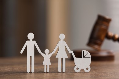 Photo of Family law. Figureparents with children and gavel on wooden table, space for text