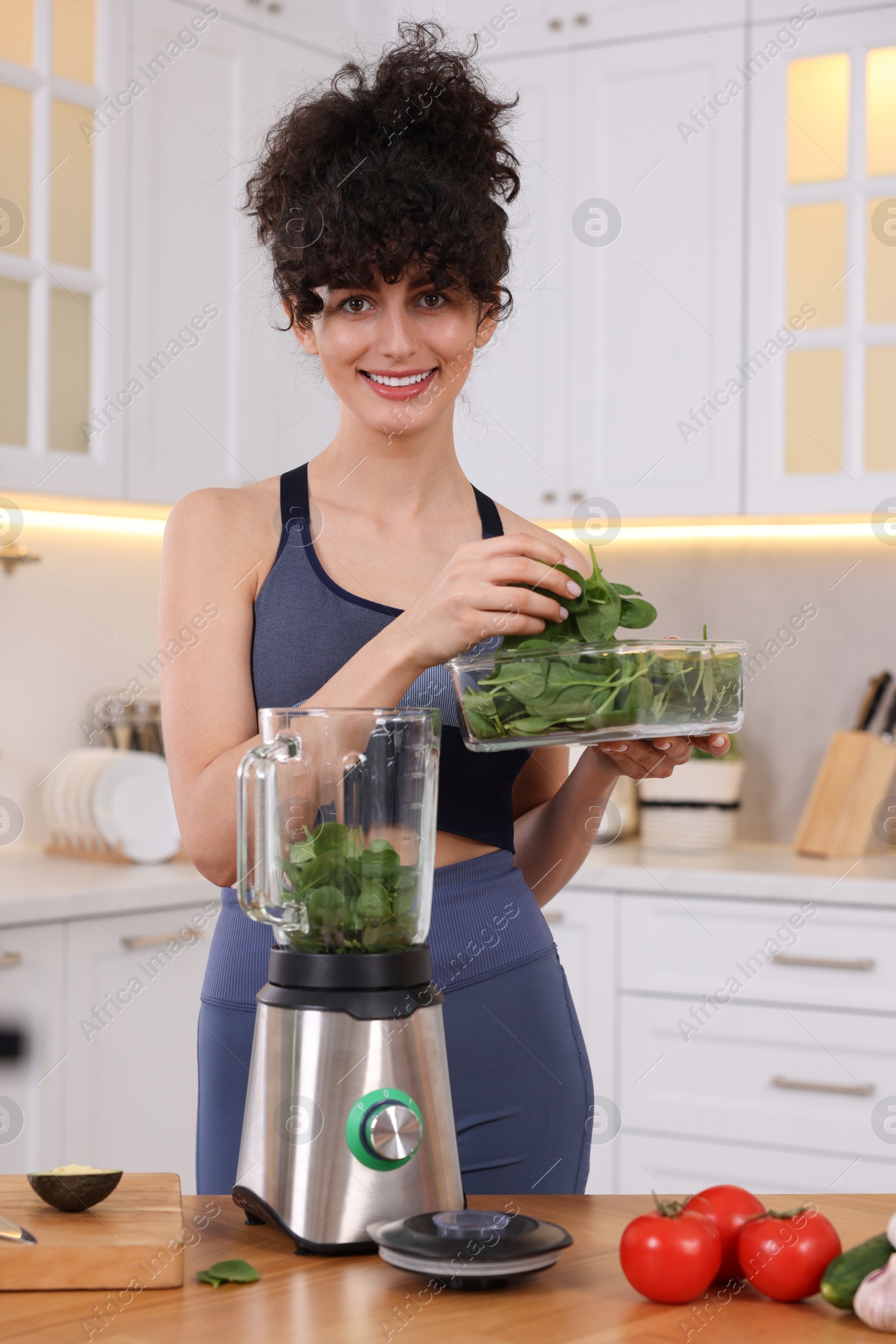 Photo of Smiling food blogger cooking in kitchen at home