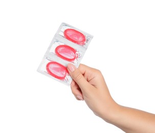 Photo of Woman holding condoms on white background, closeup