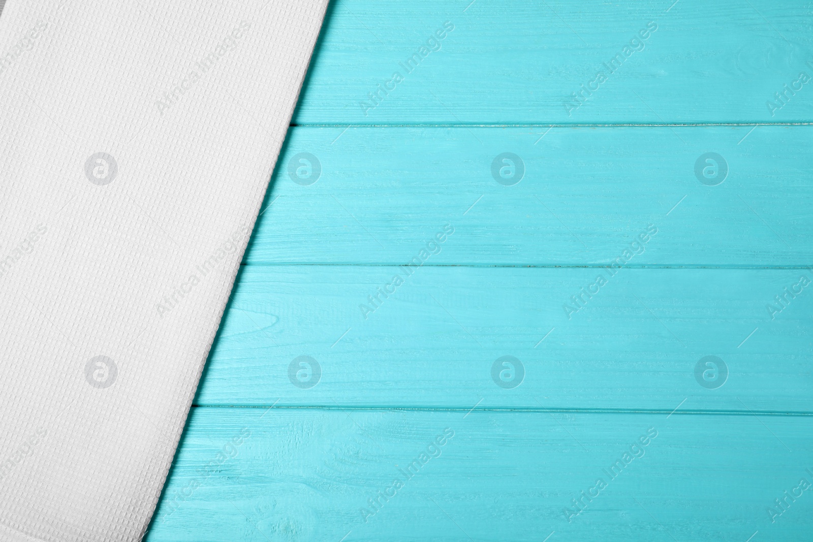 Photo of Fabric napkin and space for text on wooden background, top view