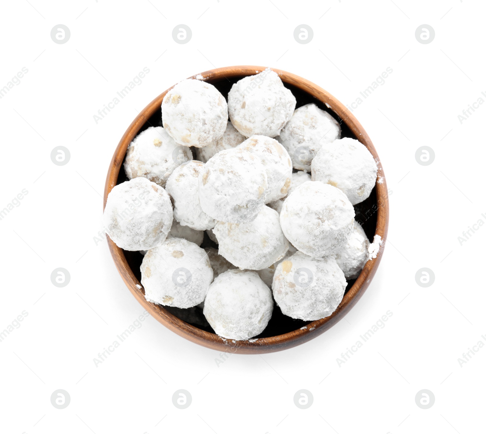Photo of Christmas snowball cookies in wooden bowl isolated on white, top view