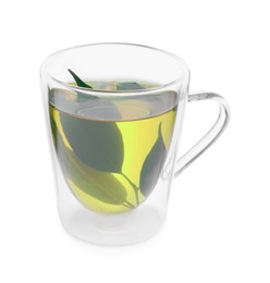 Photo of Fresh green tea in glass mug and leaves isolated on white