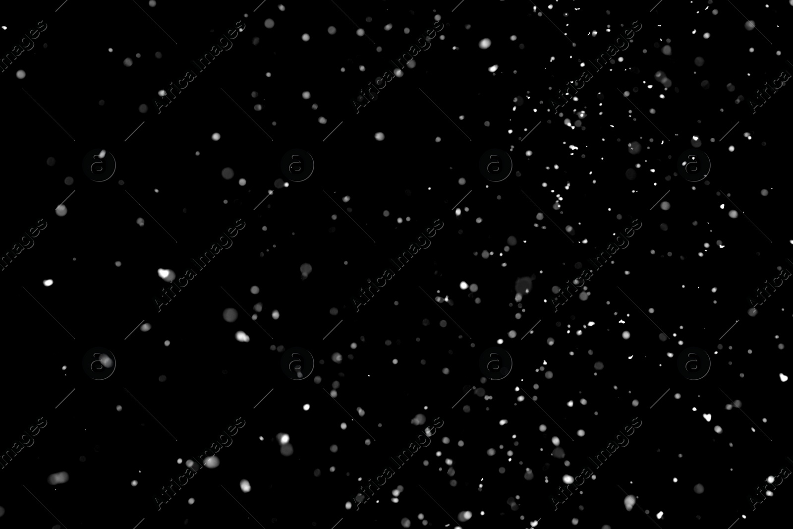 Photo of White snow falling down on black background