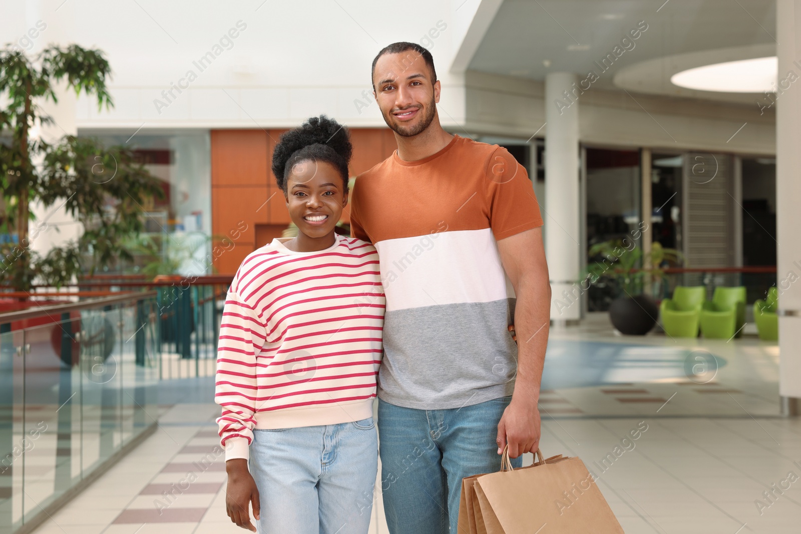 Photo of Family shopping. Happy couple with purchases in mall